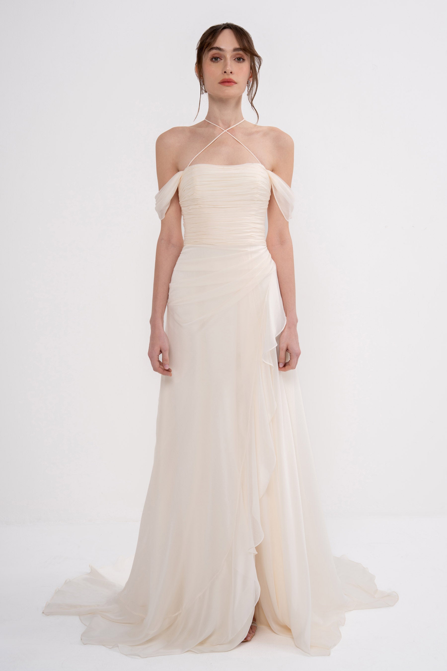 Elegant Harmonia Dress by Manel-Fashion displayed on a hanger, showcasing its flowing fabric and stylish design.