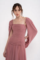 Elegant VITA dress by MANEL-FASHION displayed on a mannequin, showcasing its stylish design and flowy fabric.