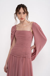 Elegant VITA dress by MANEL-FASHION displayed on a mannequin, showcasing its stylish design and flowy fabric.