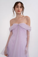 Manel-Fashion Anthea dress displayed on a hanger, featuring a stylish, modern design with vibrant colors and elegant fabric.