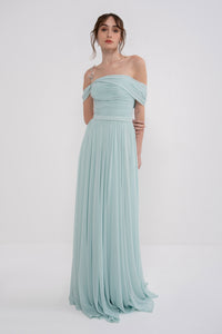Manel-Fashion Gaia dress displayed on a hanger, featuring a stylish, flowy design with floral patterns and elegant neckline.