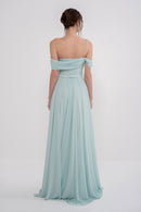 Manel-Fashion GAIA Dress in flowing fabric with a stylish design, showcased on a model in a full-length shot.