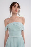 Manel-Fashion Gaia dress in flowing fabric with a stylish silhouette, showcased on a model in a well-lit studio setting.