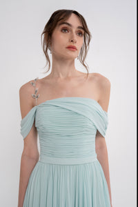 Manel-Fashion Gaia dress in flowing fabric with a stylish silhouette, showcased on a model in a well-lit studio setting.