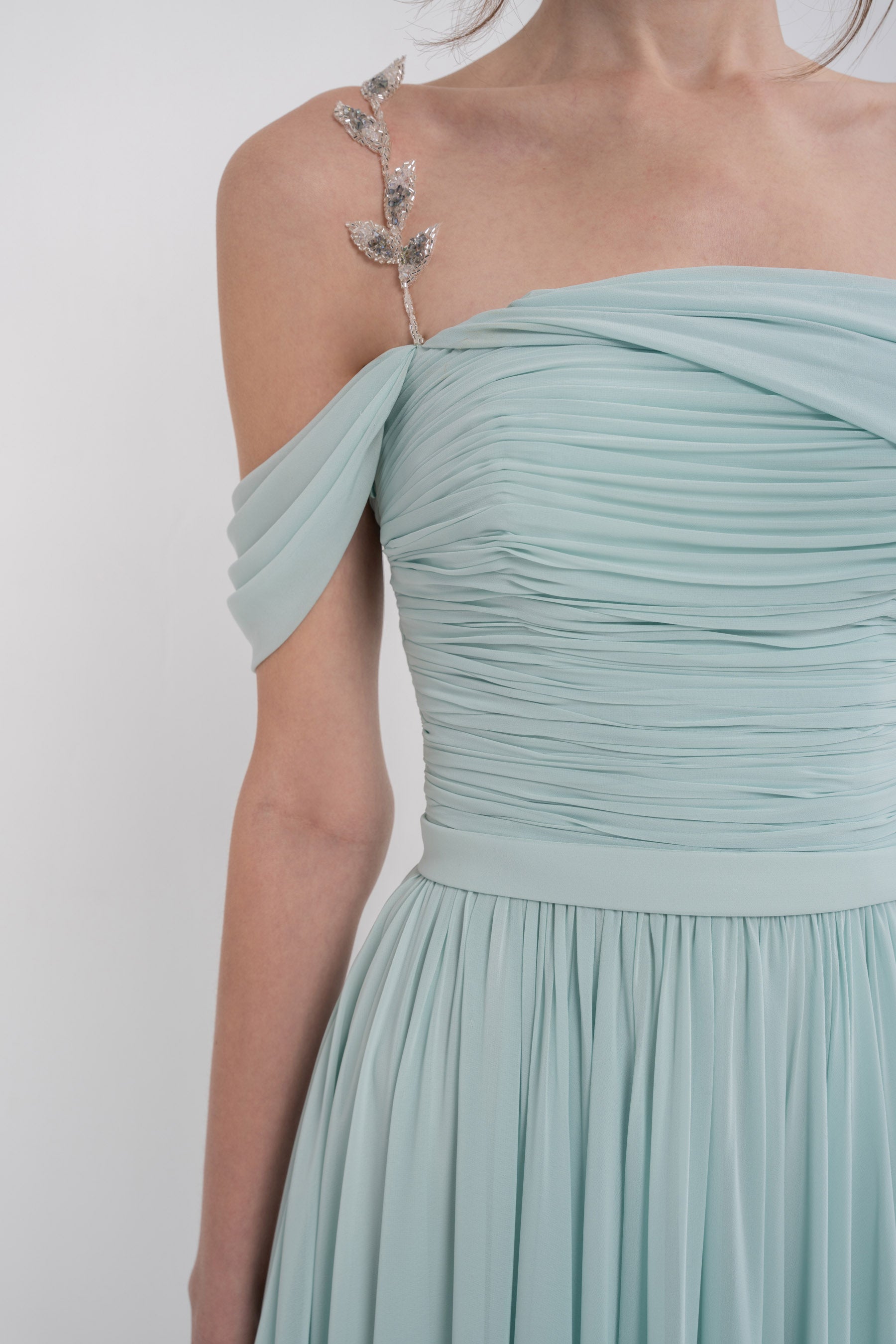Manel-Fashion Gaia dress displayed on a hanger, featuring a flowing design and stylish fabric suitable for casual or semi-formal wear.