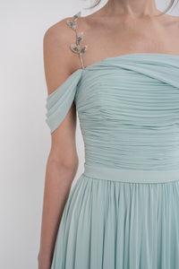 Manel-Fashion Gaia dress displayed on a hanger, featuring a flowing design and stylish fabric suitable for casual or semi-formal wear.