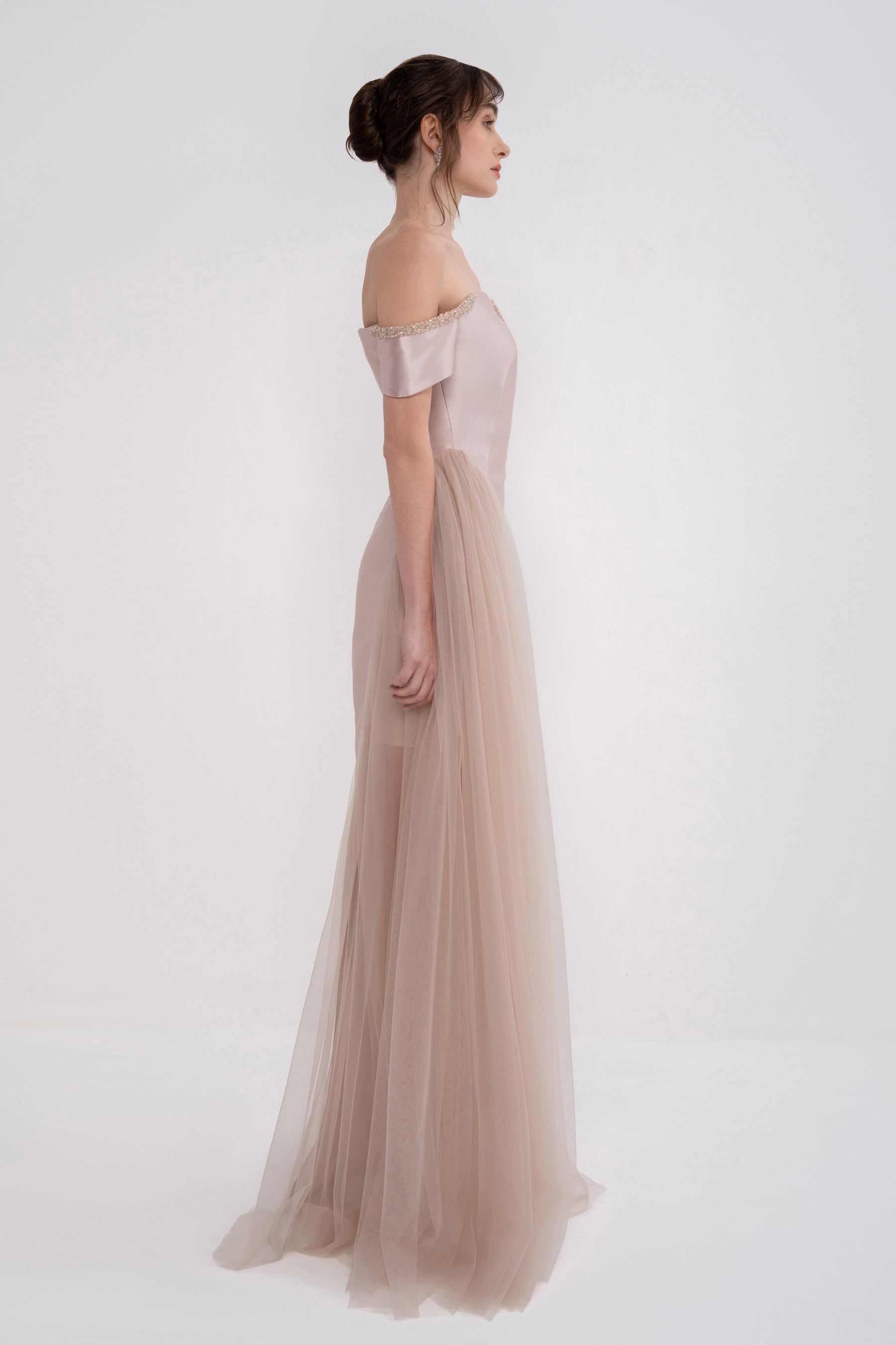 VITTORIA dress by MANEL-FASHION displayed on a hanger, featuring a stylish design with elegant fabric and a fitted silhouette.