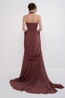 Elegant AETHER dress by MANEL-FASHION displayed on a hanger, showcasing its stylish design and fabric details.