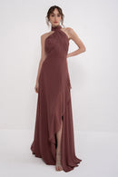 A stylish black AETHER dress by MANEL-FASHION displayed on a mannequin with elegant design details and flowing fabric.