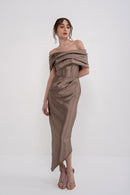 Black Nera Dress by MANEL-FASHION displayed on a hanger, showcasing its elegant design and fabric details.