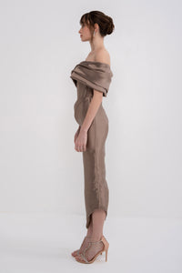 Black NERA dress by Manel-Fashion with elegant fit and stylish design, displayed on a hanger against a neutral background.