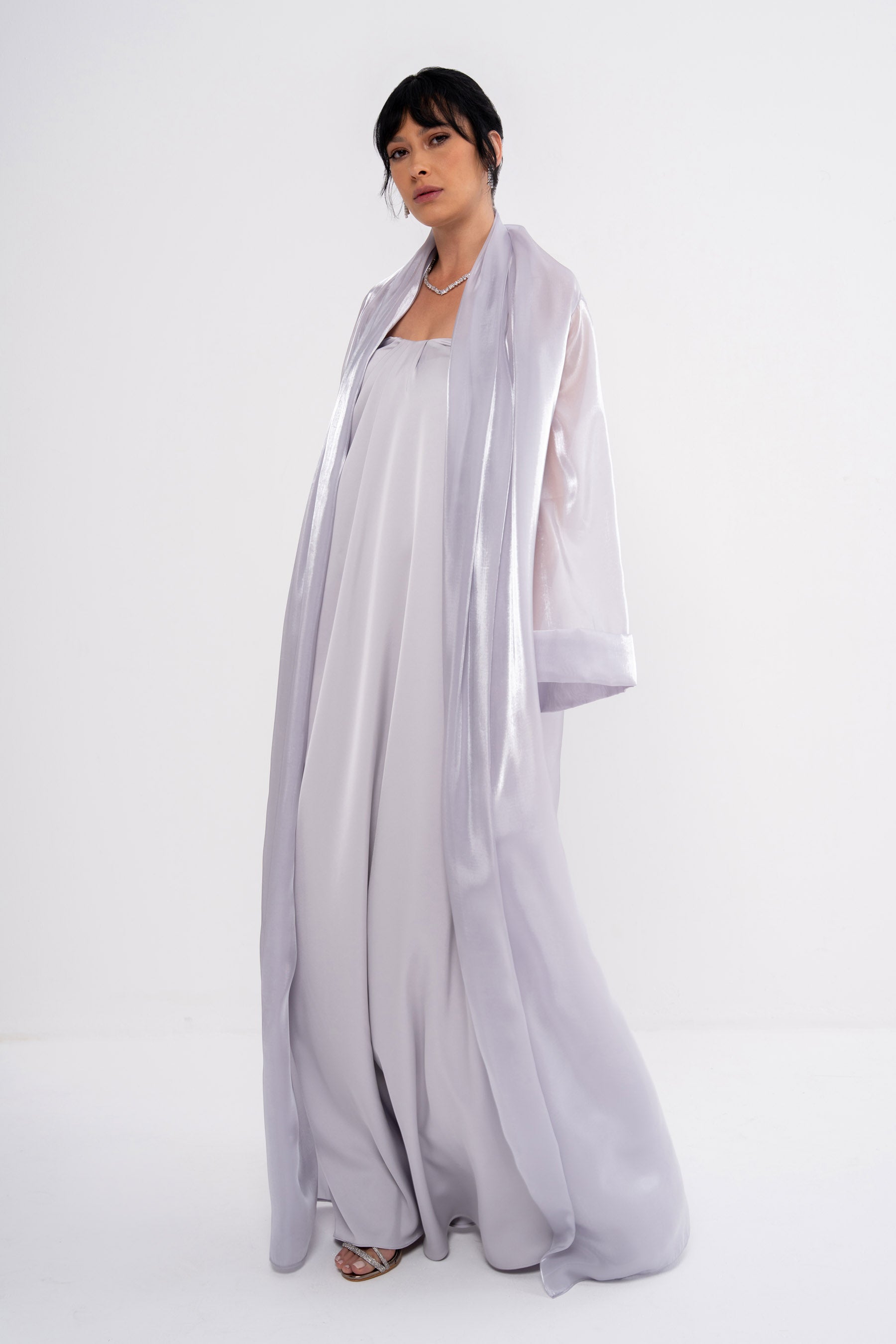 Grey CLEA dress by MANEL-FASHION displayed on a model, showcasing a stylish and elegant women's fashion piece.