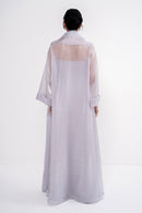 Manel-Fashion CLEA grey dress displayed on a hanger, showcasing its elegant fabric and modern design.