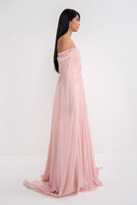 A woman wearing the elegant Aphrodite dress by Manel-Fashion, featuring flowing fabric and stylish design.