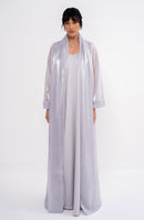Grey CLEA dress by MANEL-FASHION displayed on a hanger, showcasing its elegant design and fabric details.