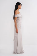 Elegant ELECTRA dress by MANEL-FASHION displayed on a hanger, showcasing its flowing fabric and stylish design.