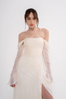 Manel-Fashion Harmonia dress displayed on a hanger, featuring a stylish design with flowing fabric and elegant details.